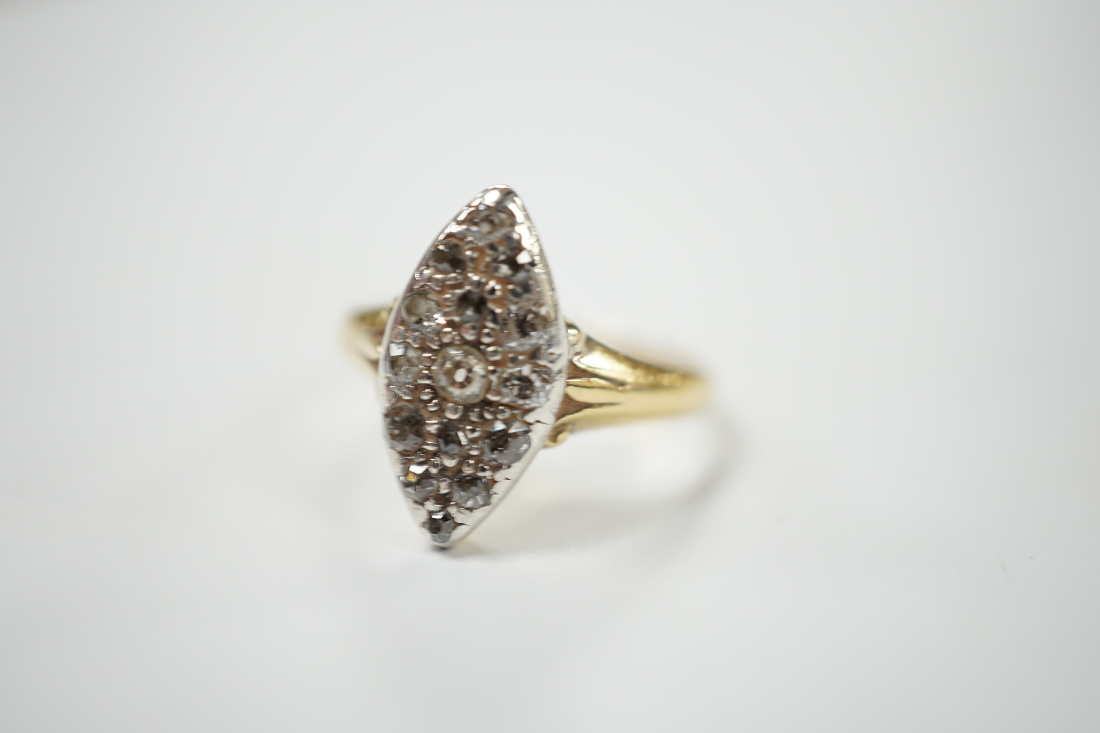 A yellow metal and diamond chip set marquise cluster ring, size K, gross weight 3 grams. Condition - fair